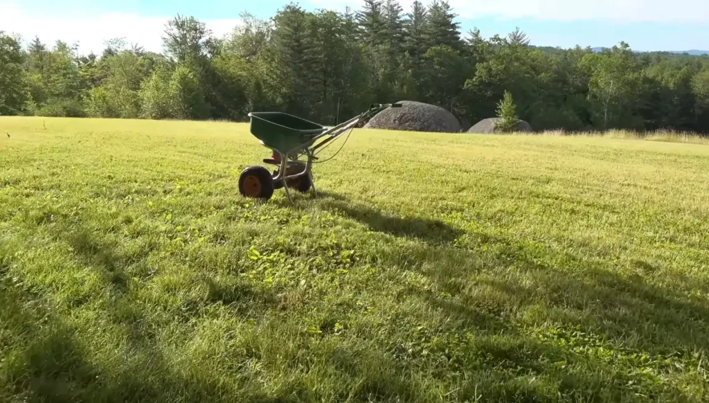 Fertilizer spreader on a freshly cut yard maintained by Waco lawn services.
