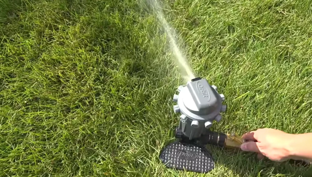 Waco lawn services sprinkler watering lush green grass and pest control